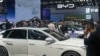 FILE - Visitors look at cars at the BYD booth during the China Auto Show in Beijing, China, Apr. 26, 2024. The EU threatened, June 12, 2024, to hike tariffs on Chinese electric vehicles, escalating a trade dispute over Beijing's subsidies for the exports.